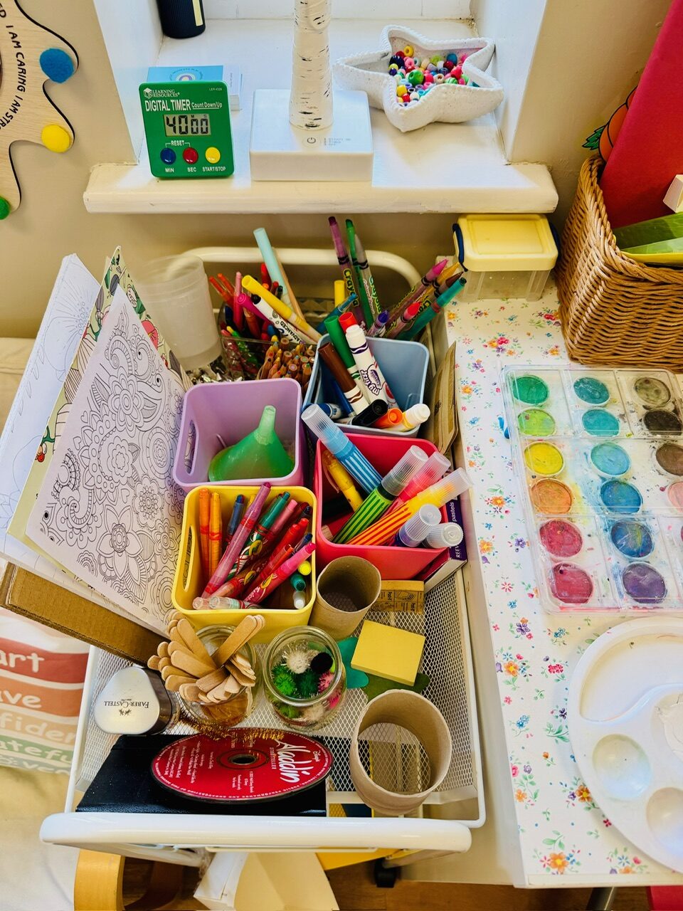 Trays of markers, paints, colouring sheets and craft materials