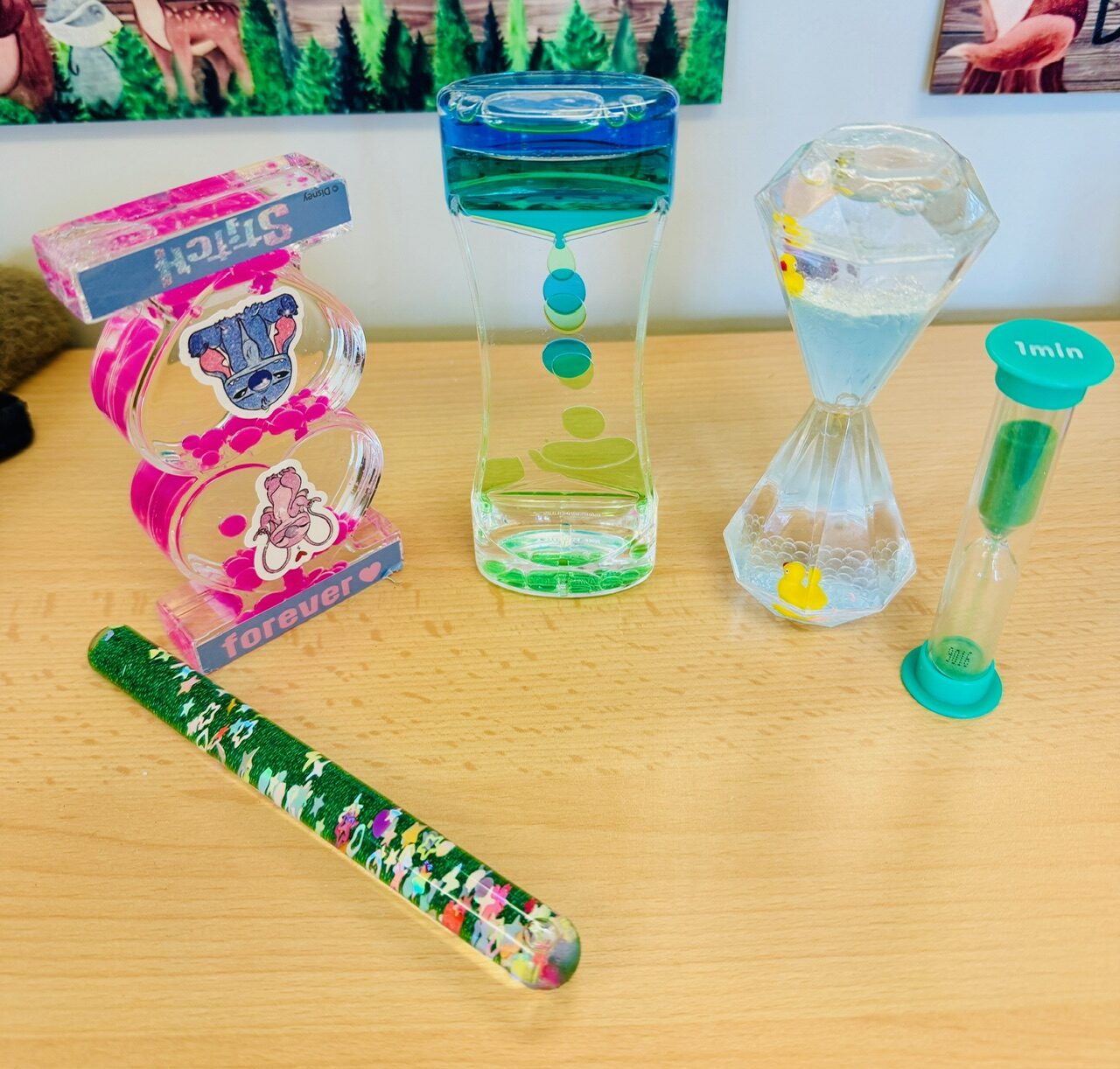 Liquid bubble timers and a glitter wand used for calming and settling