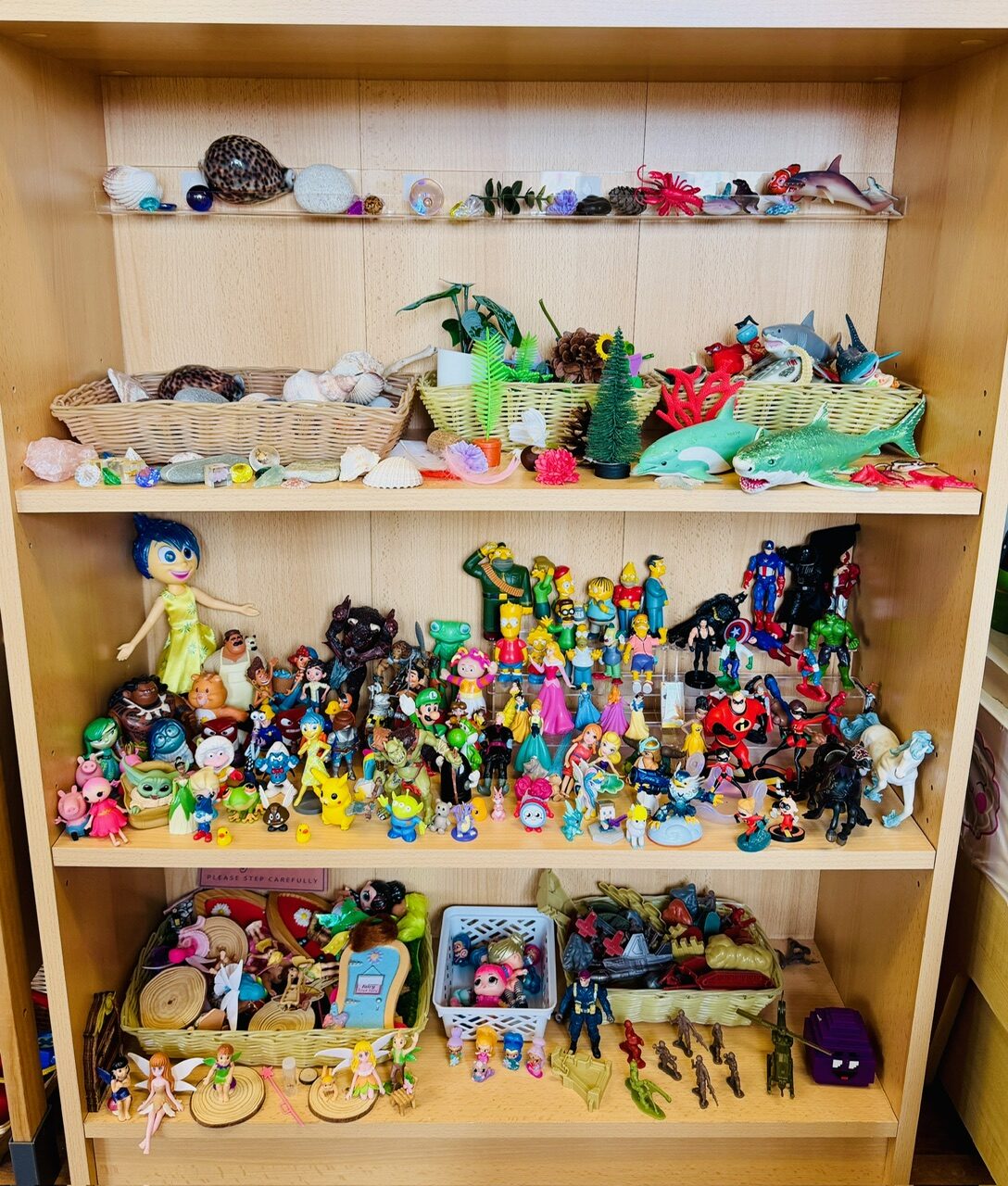 Shelves of small figures, fairies, animals and characters for small-world play